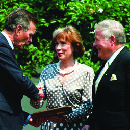 President H. W. Bush (left) presents Connie and Howard Clery with recognition of their contributions in assisting victims of campus crimes.
